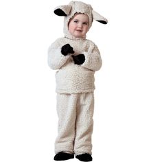 a little boy in a sheep costume standing with his arms crossed and looking at the camera