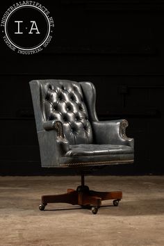 an old fashioned leather chair with wheels and casteors is shown in front of a black wall