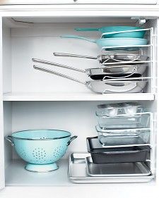 an open refrigerator filled with lots of pots and pans