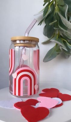 a jar filled with hearts sitting on top of a table