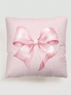 a pink pillow with a large bow on it