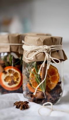 two mason jars filled with dried fruit and spices