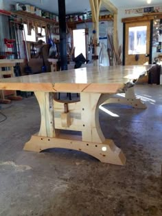 a large wooden table sitting inside of a building