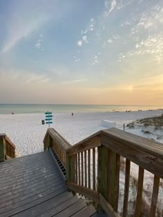 a boardwalk leading to the beach at sunset