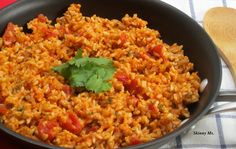 mexican rice with tomatoes and cilantro in a skillet