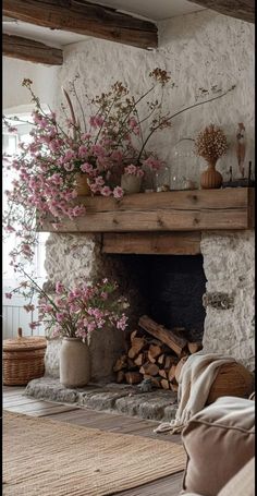 a living room with a fire place and flowers in vases on the mantel