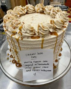 a cake with caramel sauce and vanilla frosting