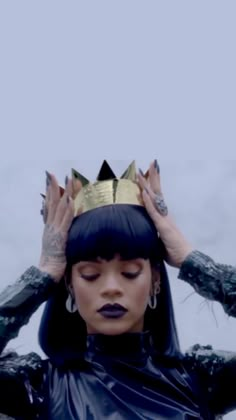 a woman with black hair wearing a crown on top of her head and hands behind her head