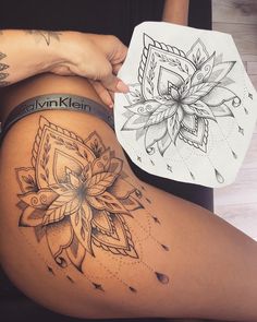 a woman's thigh with tattoos on it and a flower tattoo on the side