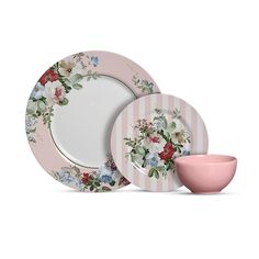 a pink and white dinner set with flowers on it