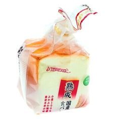 a piece of cheese wrapped in plastic on top of a white surface with chinese writing