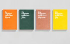 three books with different colored covers sitting on top of each other in front of a white wall