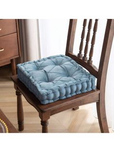 a wooden chair with a blue cushion on it