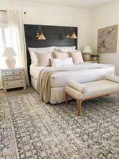 a large bed sitting on top of a rug in a bedroom