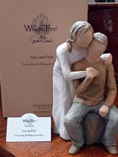 a ceramic figurine of a man hugging a woman on the back of a chair