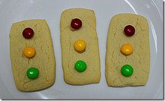 three cookies with candy candies on them sitting on a plate