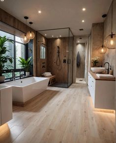 a large bathroom with wooden floors and white bathtub next to a walk in shower