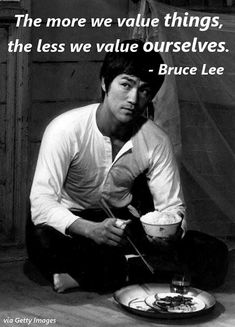 bruce lee sitting on the floor with his plate of food in front of him and quote from bruce lee