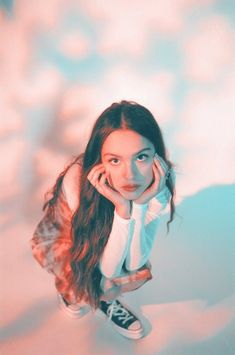 a girl with long hair is posing for the camera