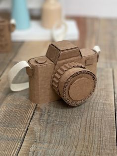 a camera made out of toilet paper sitting on top of a wooden table