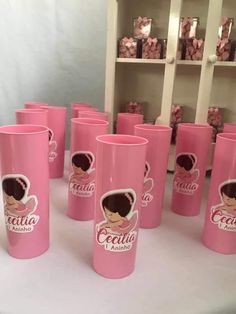 many pink cups are lined up on a white table with the name cecilia printed on them