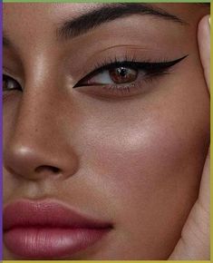 a close up of a woman's face with her hand on her head and the words, how to do eyeliners for brown eyes?