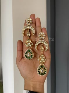 Indulge in the opulent beauty of our exquisite Kundan Dangler Earring, featuring floral stud blooms with the vibrancy of life. Descending from this floral masterpiece, a crescent-shaped Kundan unit gracefully extends, evoking the celestial allure of a moonlit night. Attached to this crescent unit is a whimsical fish-shaped Kundan element, completing this enchanting composition is a verdant green teardrop Kundan unit, suspended delicately at the bottom of the earring. Adding a touch of natural splendor completes the symphony of beauty that is our Kundan Dangler Earring. Closure - Push Back. Cheap Green Earrings With Latkans, Luxury Green Bollywood Jhumkas, Luxury Kundan Jhumkas For Festive Season, Elegant Ceremonial Chandbalis, Luxury Chandbali Earrings For Festivals, Elegant Hand Set Chandbalis For Ceremonies, Elegant Hand Set Chandbalis For Ceremonial Occasions, Elegant Hand-set Chandbalis For Ceremonial Occasions, Elegant Green Earrings For Ceremonial Occasions