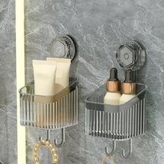 two metal holders holding toiletries in a bathroom