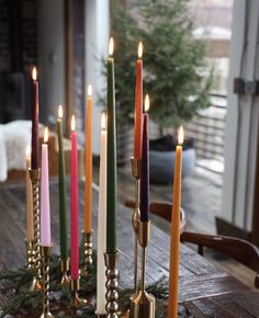 a group of candles sitting on top of a wooden table