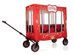 a red toy wagon with wheels and handles