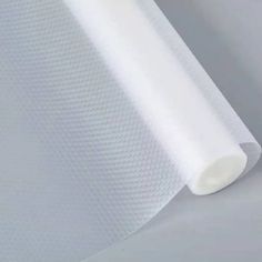 a roll of white fabric on top of a table