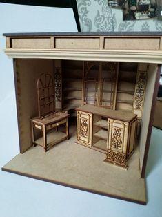 a doll house with furniture and accessories in it's display case on a table