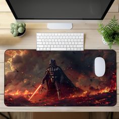 a computer mouse pad with a darth vader scene on it and a keyboard next to it