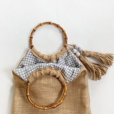 a handbag with a wooden handle and tassels