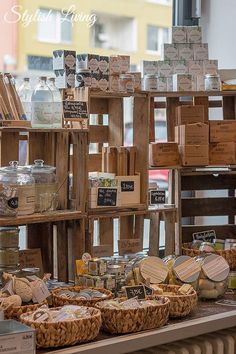 baskets and cheeses are on display in front of a window