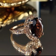 a fancy ring with a large brown stone in the center