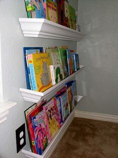 three white shelves filled with children's books