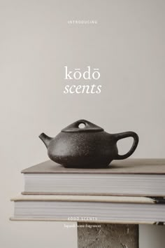 a black teapot sitting on top of a book with the title kodo scents