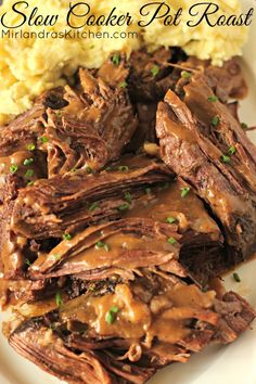 slow cooker pot roast on a plate with mashed potatoes and gravy