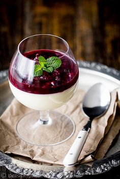 a glass filled with liquid sitting on top of a plate