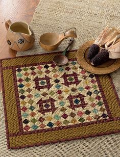 a quilted placemat with shoes on the floor next to it