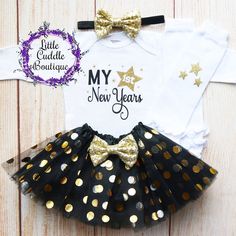 "This is an adorable New Year's outfit. This outfit features a bodysuit with the words \"My First New Years\" The outfit is complete with a matching black head and black/gold tutu. Other options to complete the outfit are a matching black headband/tutu and white leggings with gold stars on them. Other bottoms/headbands are available in the shop as well. HOW TO ORDER: 1.Bodysuit-Select Style and Size from the drop down and add to cart (S/S=Short Sleeve, L/S=Long Sleeve). 2.Add bottom and headband Cute Party Sets, Cute Fitted Party Sets, Birthday Fitted Letter Print Bodysuit, Fitted Black Sets For Birthday, Black Fitted Sets For Birthday, Cute Fitted Bodysuit For Birthday, Cute Fitted Sets For Holiday, Cute Fitted Holiday Sets, Cute Fitted Onesie For Party