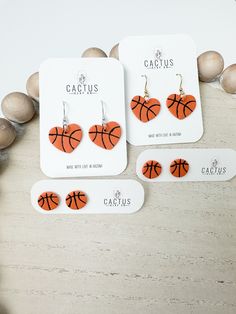 three pairs of earrings with basketballs on them