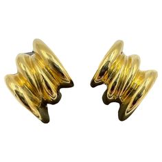 Tiffany ribbed yellow gold clip-on earrings, circa 1970s. In the glamorous era of the 1970s, fashion was bold and extravagant. One iconic piece that epitomized the style of the time was the Tiffany Ribbed Yellow Gold Clip-on Earrings. These earrings were a symbol of luxury and sophistication, worn by fashionable women who wanted to make a statement. The ribbed design of these earrings added a touch of texture and dimension to any outfit, while the yellow gold metal exuded opulence and elegance. Gold Tiffany, Status Symbol, Tiffany Earrings, Gold Clips, 1970s Fashion, Tiffany Co Jewelry, Earring Backs, Pierced Ears, Estate Jewelry