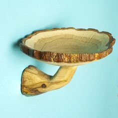 a wooden bowl is hanging on the wall