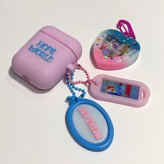 three different items are shown on a white surface, including a case and keychain