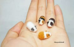 hand holding three tiny crocheted animals in it's palm