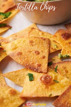 tortilla chips with salsa and cilantro in a bowl on the side