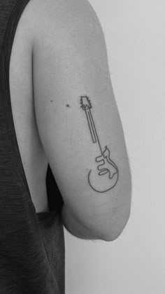 a person with a guitar tattoo on their arm