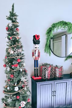 a christmas tree with decorations and a nutcracker